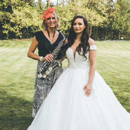 Kay holding Sax stood with the bride Emma at Hutton Hall