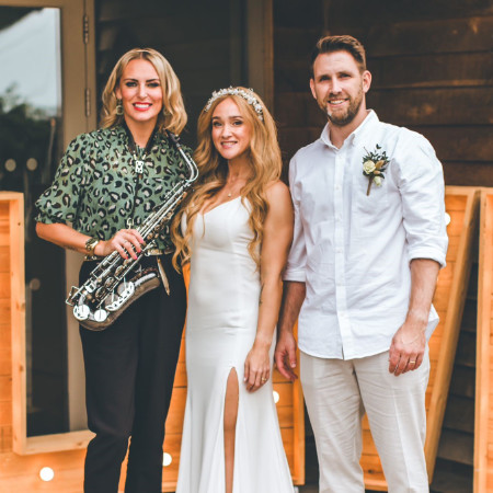 Kay holding Sax standing with bride Ophelia and Matthew the groom
