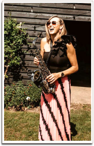 Kay laughing and holding the Sax