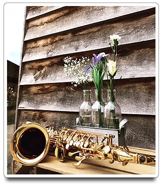 Pre-ceremony Music package collage - Sax with flowers in bottles infront of aged wood